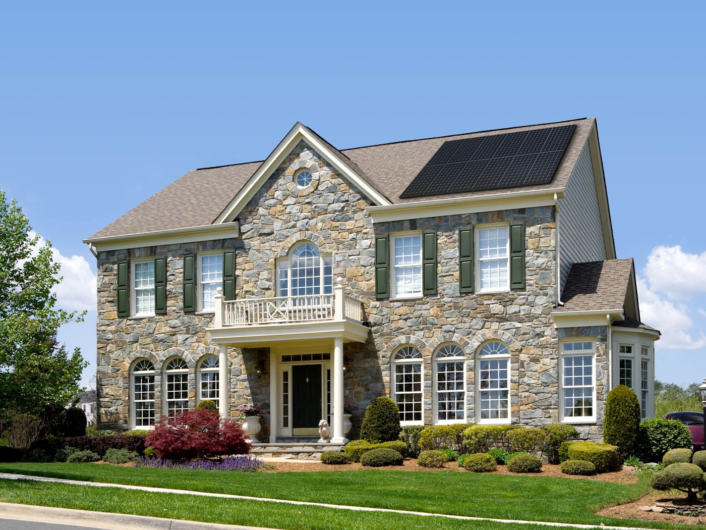 A beautiful home with solar panels - learn about the benefits of regular solar panel maintenance in Alpharetta, GA.